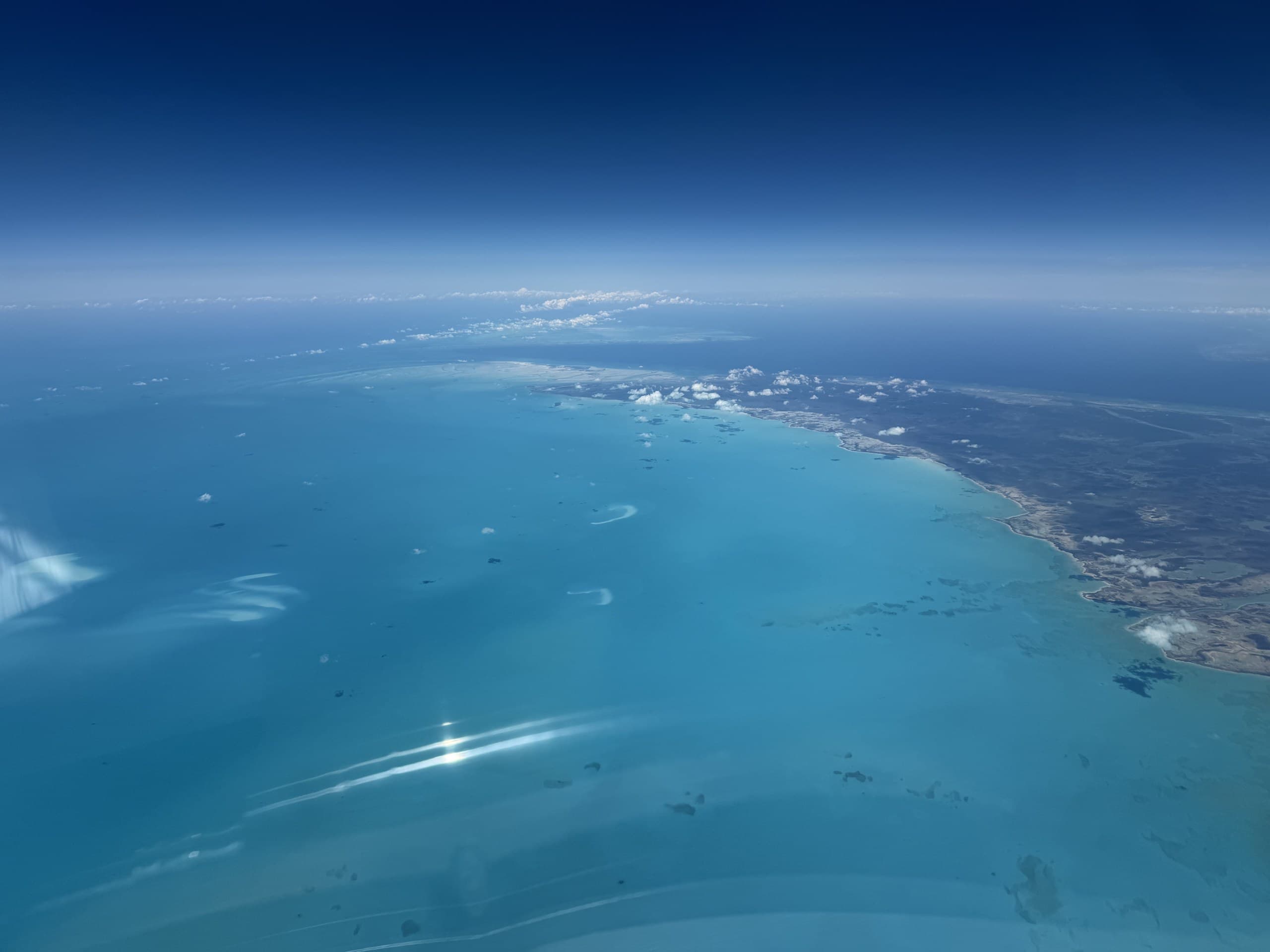 Pilot flying over coastal landscape